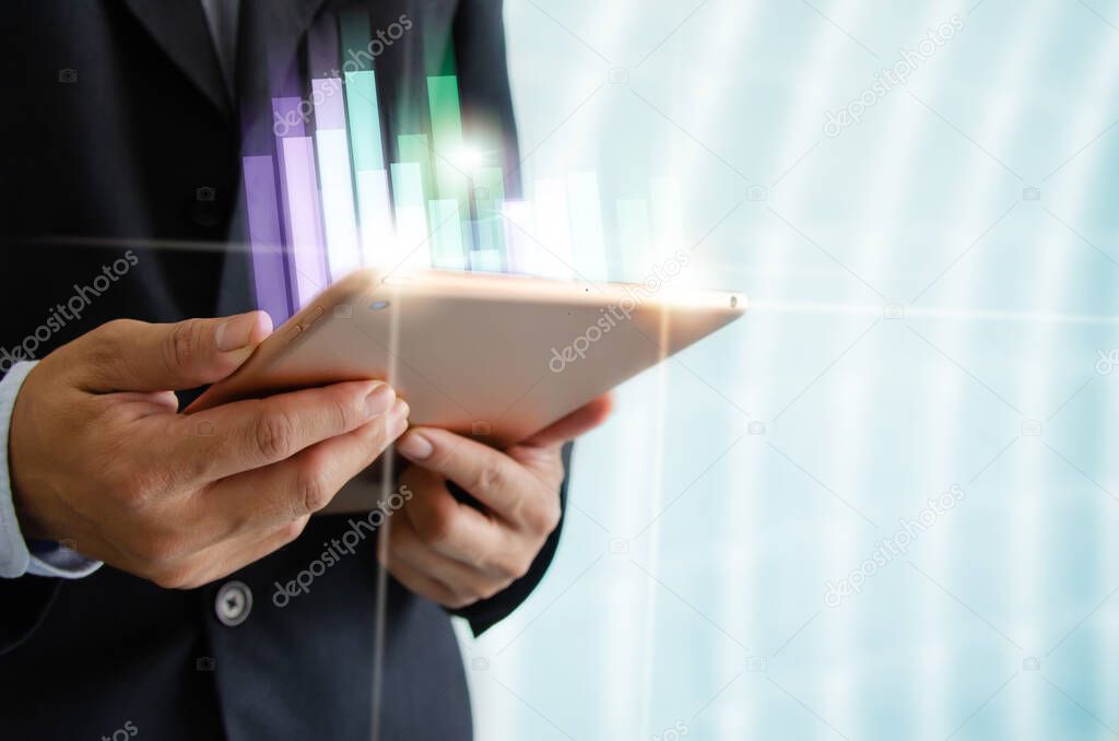 Businessman holding tablet and graph. Financial investment business and funds or stocks. Digital marketing networking connection on virtual screen, Business technology concept