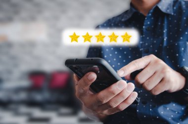 El ele tutuşan adam cep telefonu ikonu Yıldız Puanı 5 yıldızlı mükemmel reyting ya da yorum servisi kullanıyor. Sosyal konsept.
