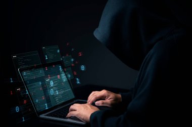 Bilgisayarı ve sanal verisi olan koyu renk kapüşonlu bir bilgisayar korsanı. Yasadışı anonim internet suç faaliyeti ve mahremiyet ihlali, sistem ağı teknolojisi.