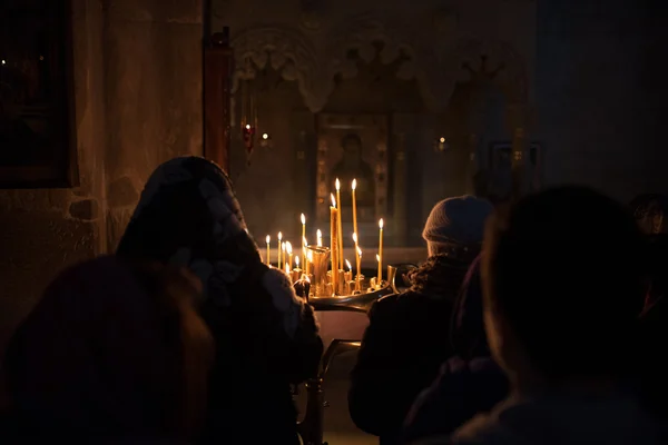 Prayer near the candles — Stock Photo, Image