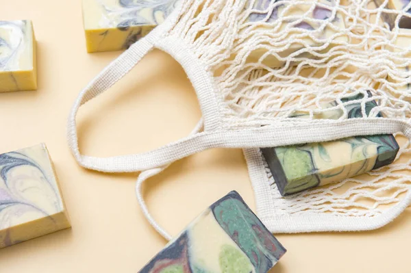 String bag or mesh bag with natural hand made soap. Zero waste, eco friendly cosmetics concept.
