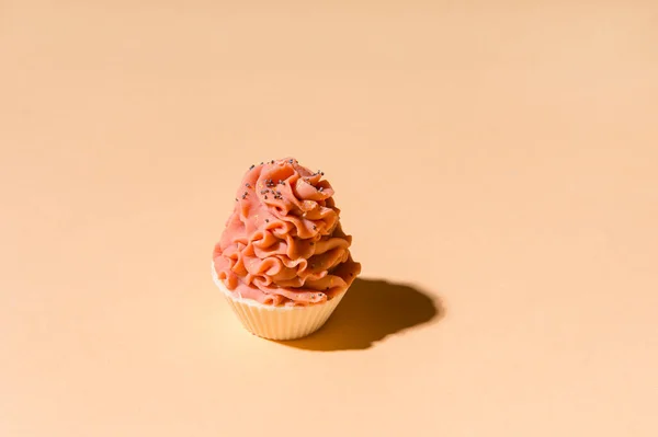 Natural handmade soap, cupcake with cream on cream color background. Zero waste, eco friendly cosmetics concept.