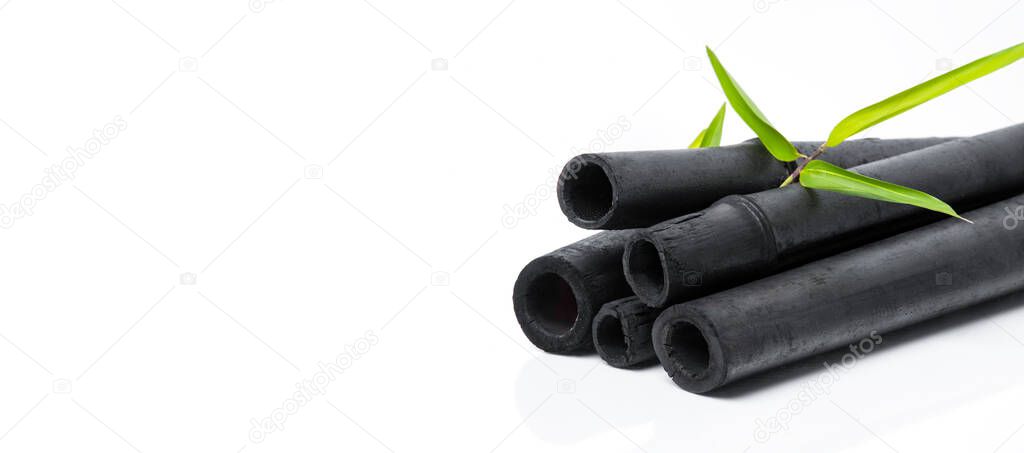 Bamboo charcoal water filter sticks and green leaf. Natural bamboo charcoal is a powerful purifier which refreshes tap water. Deodorization, air filtration, and decor concep