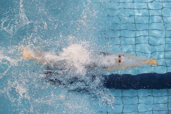 Swimmer, that jumping and diving into indoor sport swimming pool. Professional sport concept. Horizontal sport poster, greeting cards, headers, website