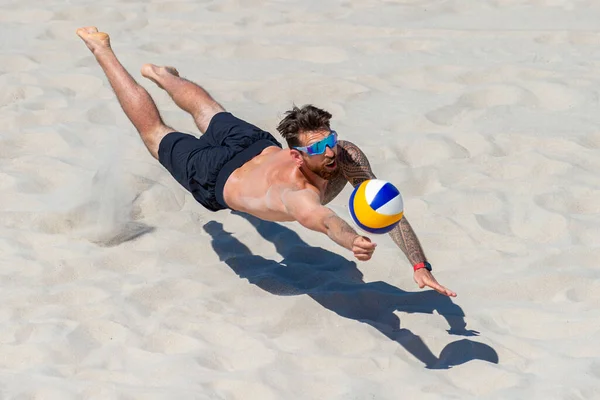 Professional beach volleyball player in action, receiving the ball. Horizontal sport poster, greeting cards, headers, website