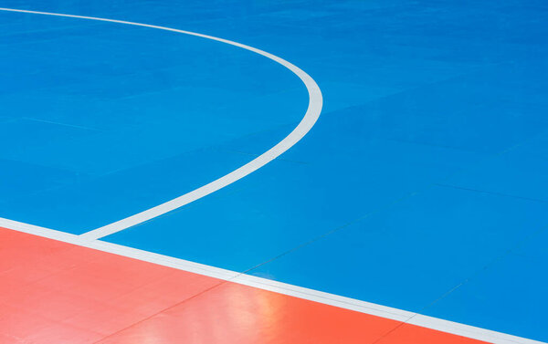 Blue and orange floor volleyball, basketball, badminton, futsal, handball court. Wooden floor of sports hall with marking lines line on wooden floor indoor, gym court