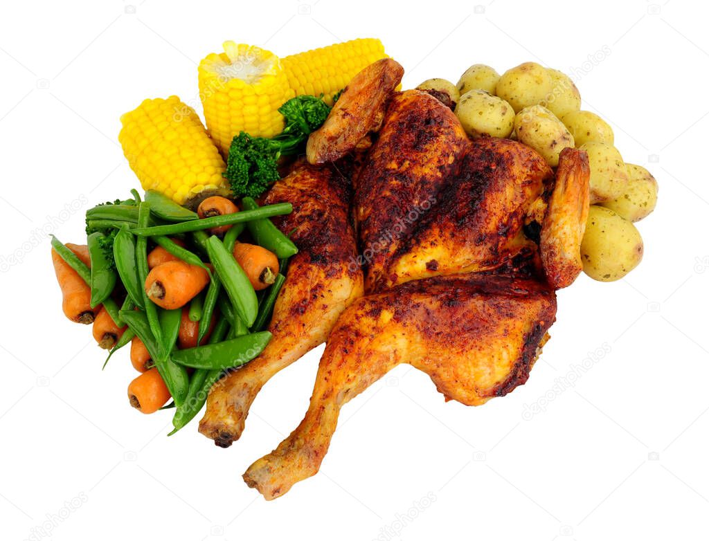 Roasted spatchcock chicken with piri piri seasoning and mixed vegetables isolated on a white background