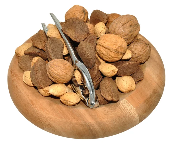 Sekoitettu pähkinät puinen lautasen — kuvapankkivalokuva