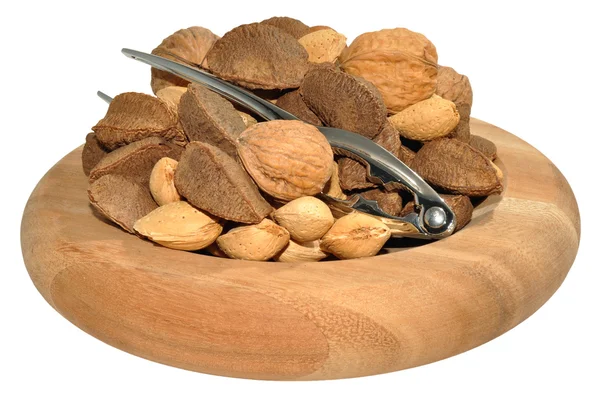 Sekoitettu pähkinät puinen lautasen — kuvapankkivalokuva