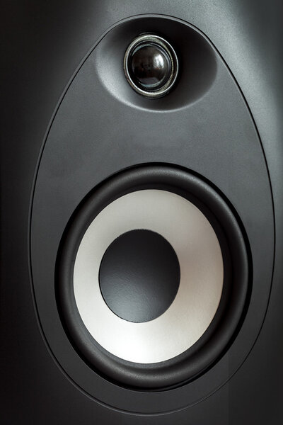 The studio monitor on a white background, the isolated image of an acoustic column with the light loudspeaker.