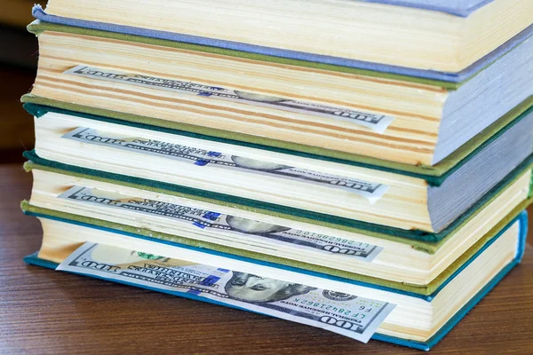 Hundred dollars lie between pages. — Stock Photo, Image