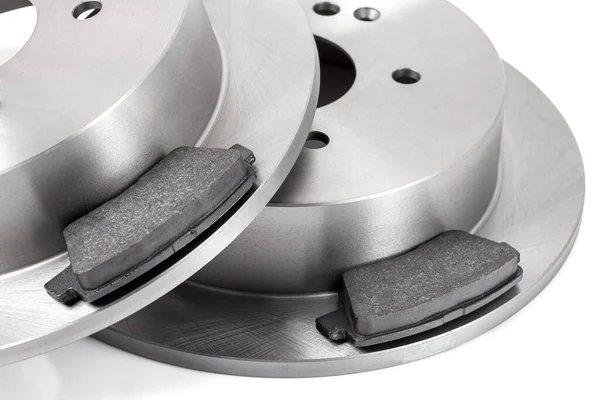 set of brake pad and brake disc new car spare parts brakes for a vehicle close up isolated on a white background close up view, nobody.
