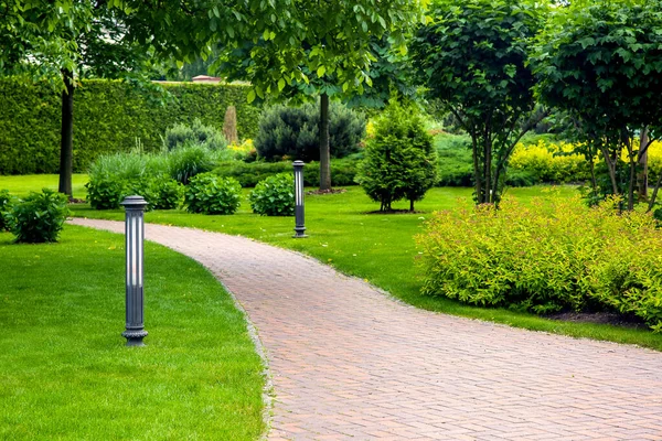 Curved Pedestrian Pavement Stone Tiles Park Landscaping Green Plants Bushes Royalty Free Stock Photos