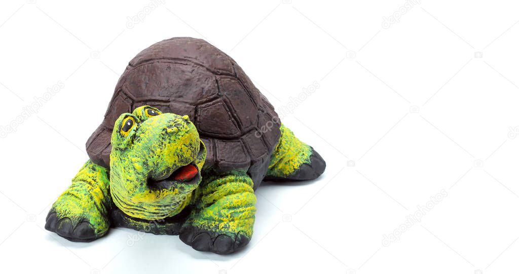 Concrete tortoise garden figure painted with colored paints, landscape object in the form of a cheerful turtle with a brown shell and a green head isolated on a white background.
