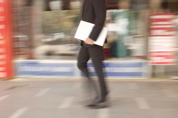 Affärsman med en laptop promenader — Stockfoto
