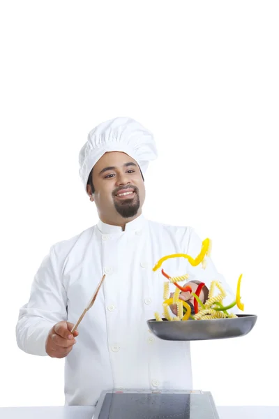 Chef tossing food in pan — Stock Photo, Image