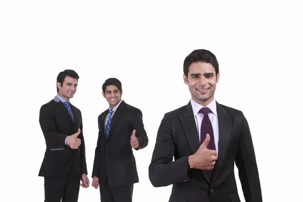 Businessmen giving thumbs up — Stock Photo, Image