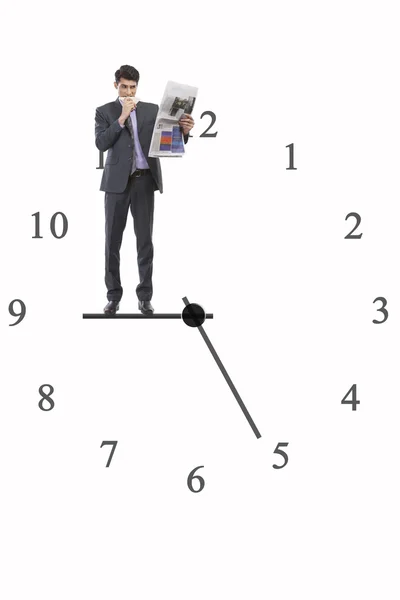 Businessman standing on clock hand — Stock Photo, Image