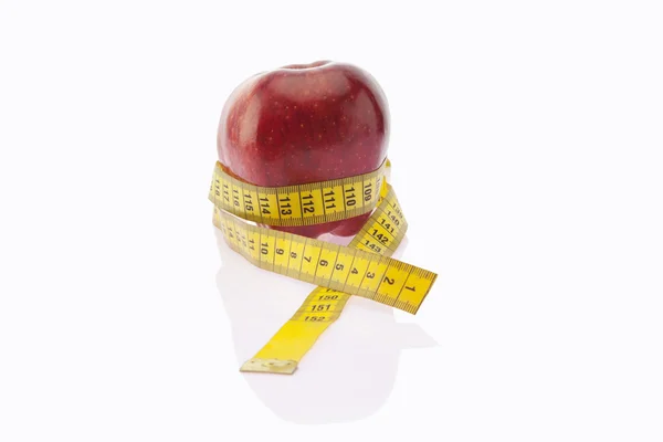 Apple wrapped with measuring tape — Stock Photo, Image