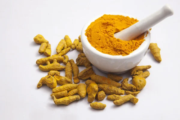 Mortar with Turmeric roots — Stock Photo, Image