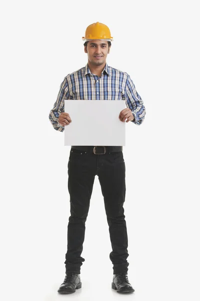 Smiling contractor holding copyspace — Stock Photo, Image
