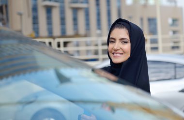 Emarati Arab Business woman in the car clipart