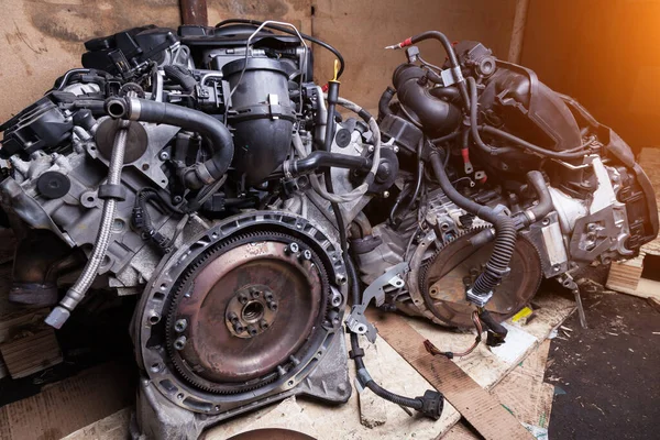 Two powerful tuned gasoline engine with a turbocharger and charger in the engine compartment in disassembled form, removed from the car in a car workshop for auto parsing. Junkyard.