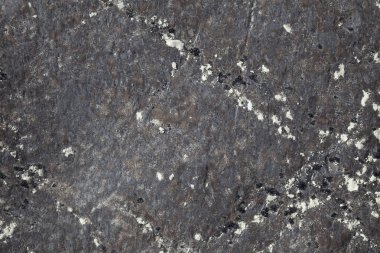 Tasarım ve jeoloji için farklı desenlere sahip antik bir kayanın arka planı ve dokusu.