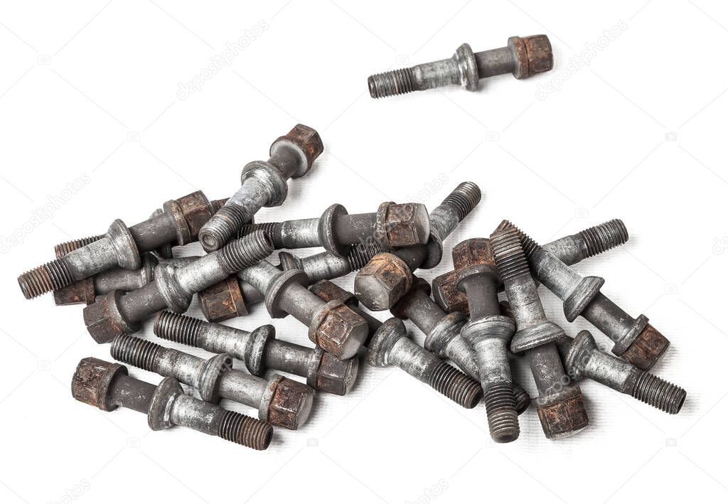 A handful of metal bolts to fix the wheels and prevent theft of the car on a white background in a photo studio. Spare consumables for replacement during repair or for sale.