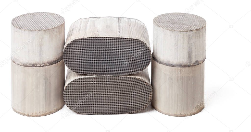 Six round and oval ceramic catalysts containing platinum, palladium and rhodium on a black background. Processing and acceptance of non-ferrous metals.