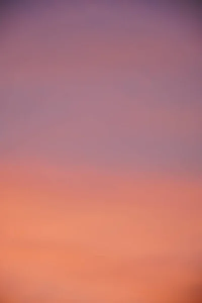 Abstract blurred orange purple and blue clouds gradient color and sky sunset on evening nature background.