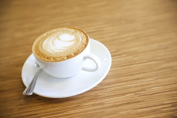 Heißer Cappuccino mit weißer Tasse auf Holztisch Kaffeehaus — Stockfoto