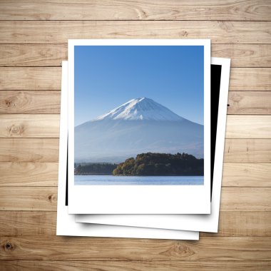 Mt. Fuji Japan memory on photo frame brown wood plank background clipart