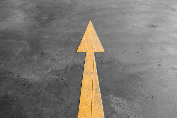 Yellow arrow road sign on the road