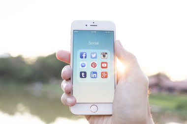 CHIANG MAI, THAILAND - JANUARY 02, 2015: All of popular social media icons on smartphone device screen with hand holding on Apple iPhone 6.