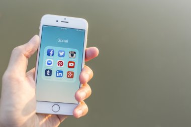CHIANG MAI, THAILAND - JANUARY 02, 2015: All of popular social media icons on smartphone device screen with hand holding on Apple iPhone 6.