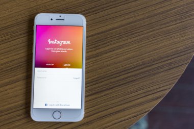 CHIANG MAI, THAILAND - JANUARY 02, 2015: A man trying to log in Instagram application using Apple iPhone 6. Instagram is largest and most popular photograph social networking site in the world.