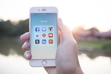 CHIANG MAI, THAILAND - JANUARY 02, 2015: All of popular social media icons on smartphone device screen with hand holding on Apple iPhone 6.