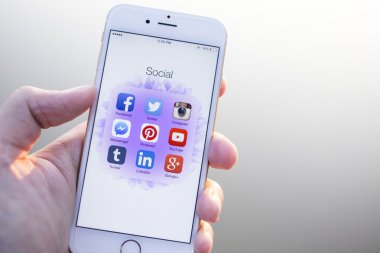 CHIANG MAI, THAILAND - JANUARY 02, 2015: All of popular social media icons on smartphone device screen with hand holding on Apple iPhone 6.