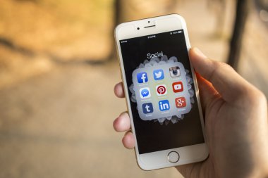 CHIANG MAI, THAILAND - JANUARY 04, 2015: All of popular social media icons on smartphone device screen with hand holding on Apple iPhone 6.
