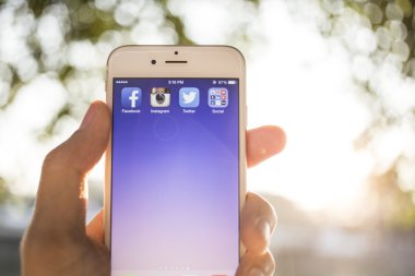 CHIANG MAI, THAILAND - JANUARY 04, 2015: All of popular social media icons on smartphone device screen with hand holding on Apple iPhone 6.