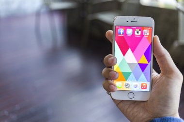 CHIANG MAI, THAILAND - JANUARY 02, 2015: All of popular social media icons on smartphone device screen with hand holding on Apple iPhone 6.