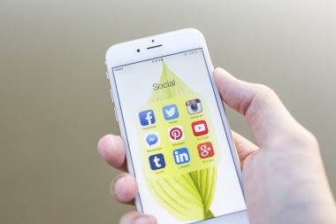 CHIANG MAI, THAILAND - JANUARY 02, 2015: All of popular social media icons on smartphone device screen with hand holding on Apple iPhone 6.