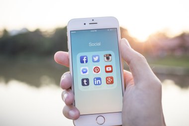 CHIANG MAI, THAILAND - JANUARY 02, 2015: All of popular social media icons on smartphone device screen with hand holding on Apple iPhone 6.