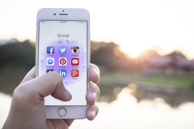 CHIANG MAI, THAILAND - JANUARY 02, 2015: All of popular social media icons on smartphone device screen with hand holding on Apple iPhone 6.
