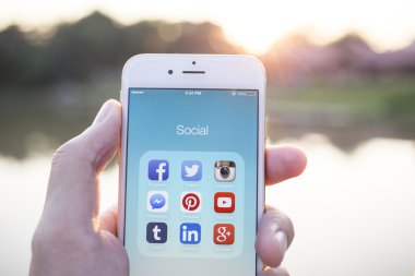 CHIANG MAI, THAILAND - JANUARY 02, 2015: All of popular social media icons on smartphone device screen with hand holding on Apple iPhone 6.