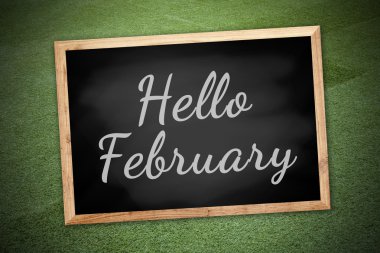 Hello February on chalk board and green field background and tex