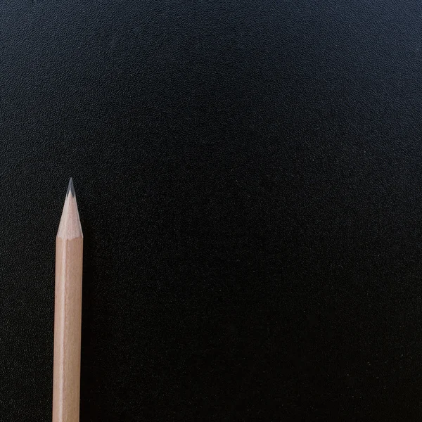 Wood pencil on blank blackboard — Stock Photo, Image