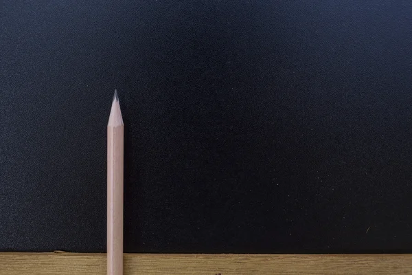 Wood pencil on blank blackboard — Stock Photo, Image