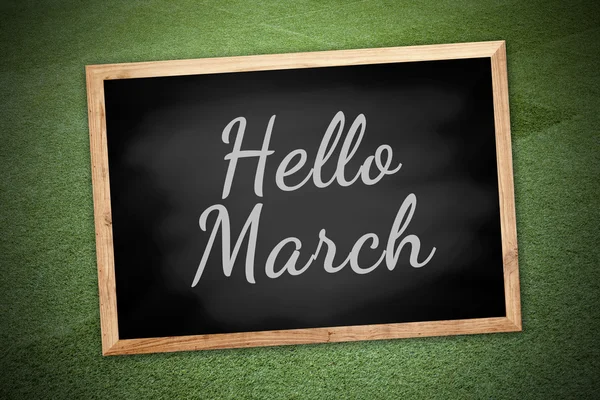 Hello march concept on chalk board and green field background and texture — Stock fotografie